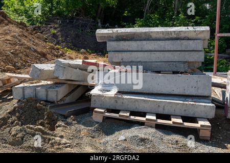 Concrete blocks for construction on wooden pallets. Storage cinder block. A construction site with concrete products. Building a house from cinder blo Stock Photo