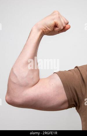 A Close up of an arm flexing bicep muscle. Stock Photo