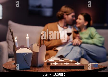 Background image of romantic evening with takeout food, happy couple drinking wine, copy space Stock Photo