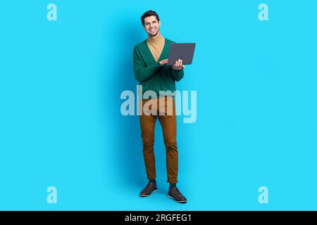 Full size body cadre of young employee man hr manager find more applicants holding laptop workaholic isolated on blue color background Stock Photo