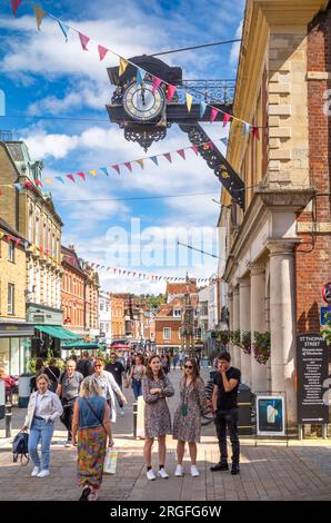 A view looking east up the High Street in historic Winchester, Hampshire, UK next to God Begot House and under the iconic Victorian iron clock. Winche Stock Photo