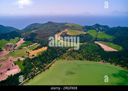 Aerial shot, drone point of view of green waters of picturesque Furnas Lake on the Azorean island of Sao Miguel Island, Azores, Portugal. Travel desti Stock Photo