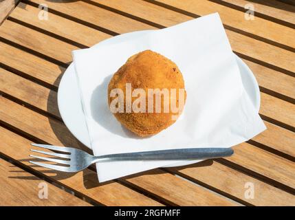 Welsh Egg on a white plate against a wooden background Stock Photo