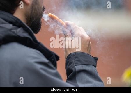 London, UK. 8 August 2023: A man vaping.  Local councils are calling for the Government to ban the sale and manufacture of single-use vapes by 2024. Stock Photo