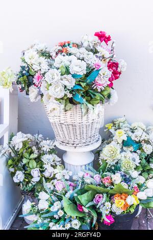 Various blooming arrangements in pots and vases as a decoration in front of a house. Vertical. Stock Photo