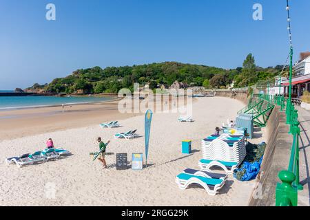 Sunbeds being placed on Saint Brélade's Bay Beach, St Brélade Parish, Jersey, Channel Islands Stock Photo