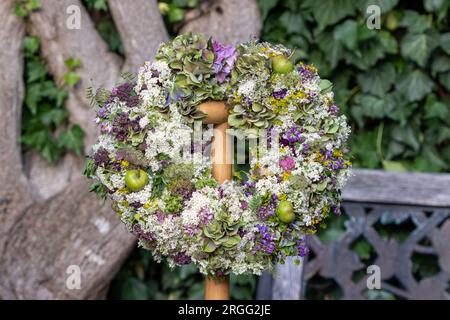 floral arrangement with wreath of meadow flowers Stock Photo