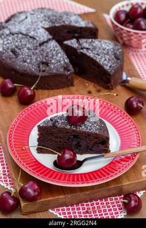 vegan chocolate cherry cake and fresh sweet cherries Stock Photo