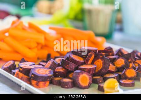 Various carrots and other vegetables cut into small pieces as a raw vegetable platter Stock Photo