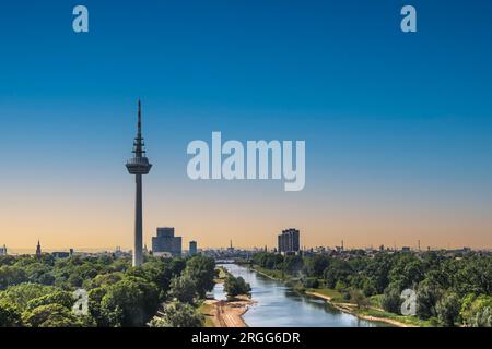 View to the Fernmeldeturm and river Neckar in Mannheim, Germany. Television TV telecommunications tower. Beautiful evening light. Copy space. Stock Photo