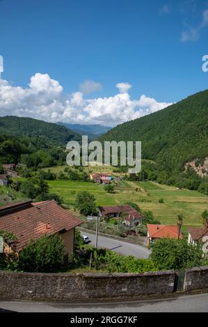Surrounded by steep wooded mountain slopes and on the valley floor of Valle Ombrosa  (Shady Valley) with olive groves and farming is the hamlet of Pos Stock Photo