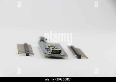 Programmable micro controller board with the unsoldered pins isolated on white background Stock Photo