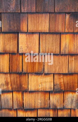 Wooden Cedar shingles used as a protective layer on the outside of a building Stock Photo