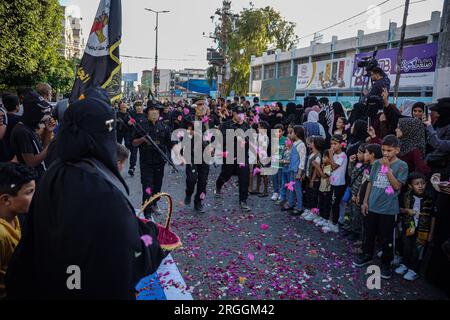 Gaza, Gaza, Palestine. 9th Aug, 2023. Members of the Al-Quds Brigades march in front of children and women (Credit Image: © Saher Alghorra/ZUMA Press Wire) EDITORIAL USAGE ONLY! Not for Commercial USAGE! Stock Photo