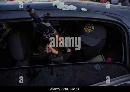 Gaza, Gaza, Palestine. 9th Aug, 2023. A member of the Al-Quds Brigades takes his rifle out of the car window during a military march in Rafah, southern Gaza Strip (Credit Image: © Saher Alghorra/ZUMA Press Wire) EDITORIAL USAGE ONLY! Not for Commercial USAGE! Stock Photo