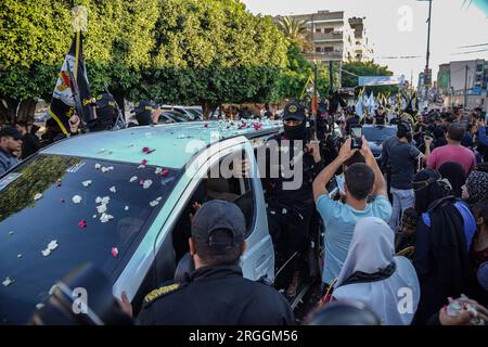 Gaza, Gaza, Palestine. 9th Aug, 2023. Women and children scatter flowers and take pictures of members of the Al-Quds Brigades (Credit Image: © Saher Alghorra/ZUMA Press Wire) EDITORIAL USAGE ONLY! Not for Commercial USAGE! Stock Photo