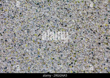 Rendered exterior stucco wall using small pebbles and broken green glass for decoration Stock Photo