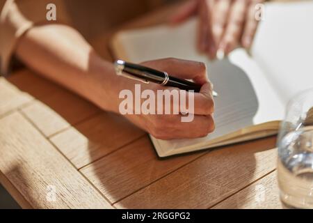 Hand of businesswoman writing notes Stock Photo