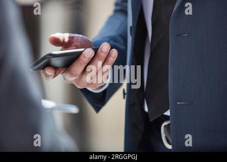 Hand of businessman using smartphone Stock Photo