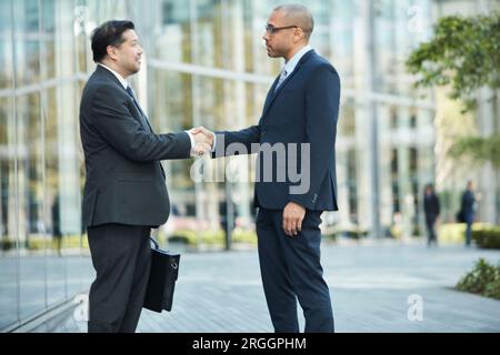 Businessmen shaking hands Stock Photo