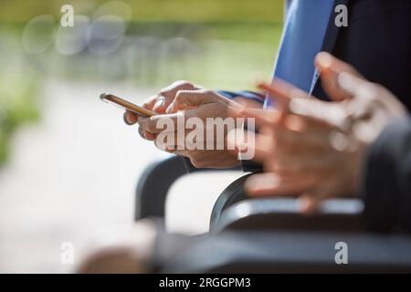 Hands of businessman using smartphone Stock Photo