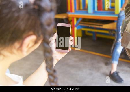 Hand of young woman holding smart phone Stock Photo