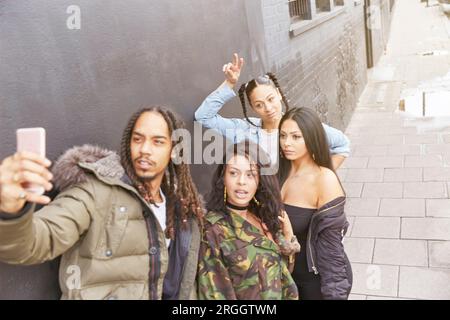 Young man taking selfie with friends Stock Photo