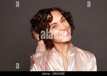 Portrait of young woman with curly hair Stock Photo