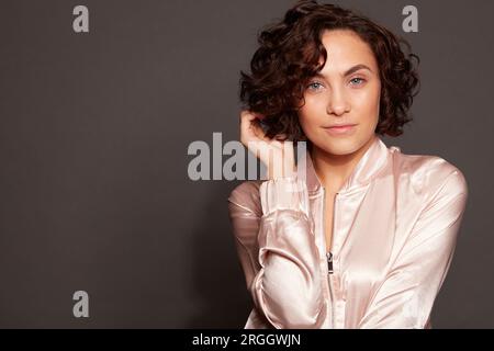 Portrait of young woman with curly hair Stock Photo