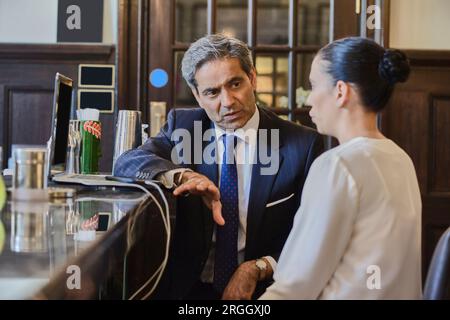 Businesspeople in meeting at bar Stock Photo