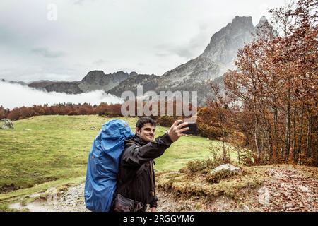 Young man taking selfie while hiking Stock Photo