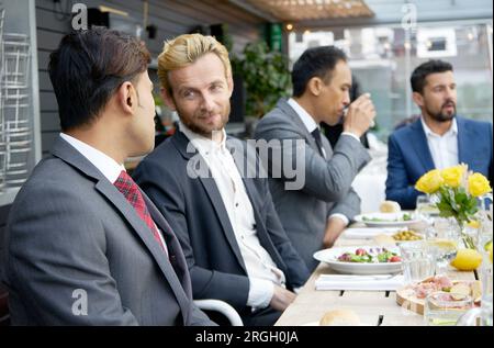 Businessmen talking during a meeting in a restaurant Stock Photo