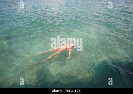 Young woman swimming in sea Stock Photo