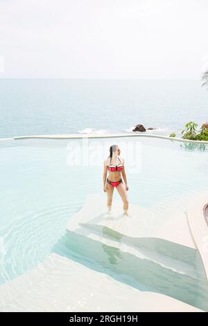 Young woman wearing red bikini in swimming pool Stock Photo - Alamy