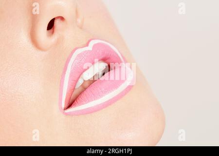 Lips of young woman with pink lipstick Stock Photo