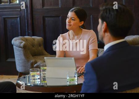 Businesspeople in meeting at bar Stock Photo