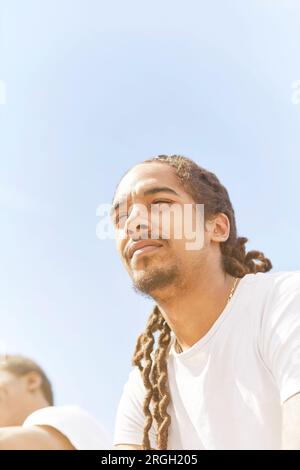 Young man against clear sky Stock Photo