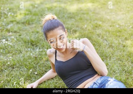 Young woman lying in grass Stock Photo