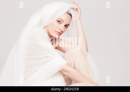 Young woman wrapped in sheer sheet Stock Photo