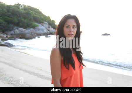 Black haired young woman on beach Stock Photo