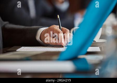 Hand of businessman holding pen Stock Photo