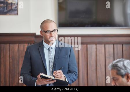 Businessman taking notes during meeting Stock Photo