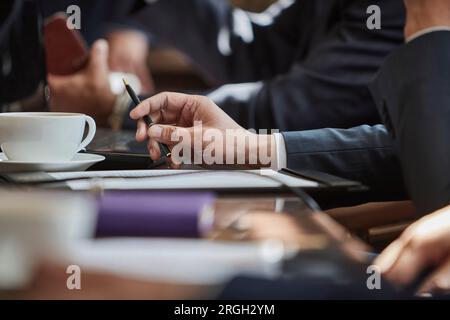Hand of businessman holding pen Stock Photo