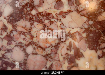 Off white cream and dark red Italian marble with significant veining in an old building in Italy Europe Stock Photo