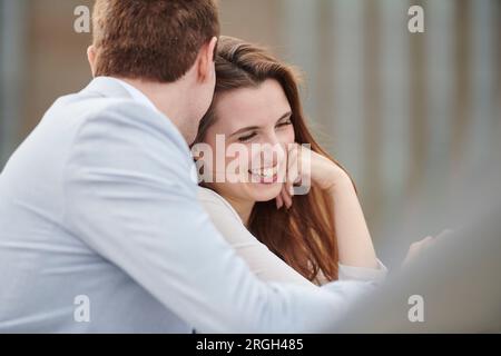 Mid adult couple leaning on railing Stock Photo