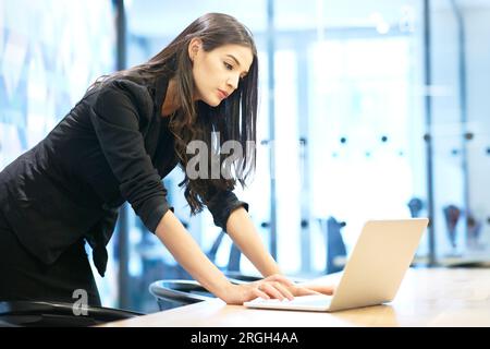 Businesswoman using laptop Stock Photo