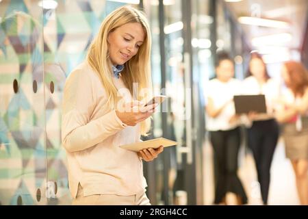 Young businesswoman using smart phone Stock Photo