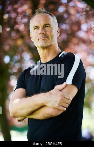 Portrait of mature man with his arms crossed Stock Photo