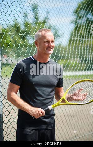 Mature man holding tennis racket Stock Photo