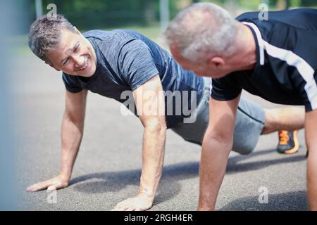 Mature men doing push-ups Stock Photo